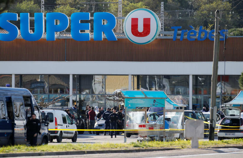 A general view shows gendarmes and police officers at a supermarket after a hostage situation in Trebes, France, March 23, 2018 (photo credit: REUTERS/REGIS DUVIGNAU)