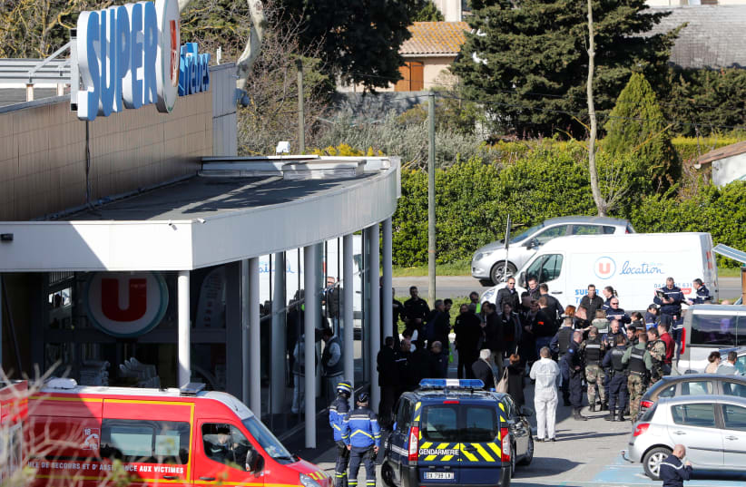 Rescue and police forces at Super U in Trebes, France during a hostage situation there (photo credit: JEAN-PAUL PELISSIER / REUTERS)