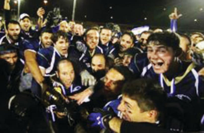 JERUSALEM LIONS players celebrate after defeating the Petah Tikva Troopers over the weekend to claim back-to-back championships in the Kraft Family Israel Football League. (photo credit: DOTAN DORON)