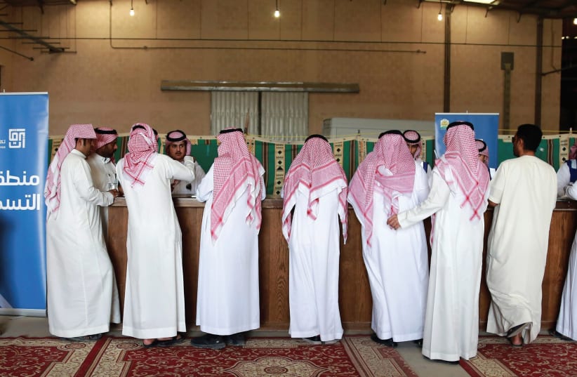 Saudi Arabian men gather for a vehicle auction. Maybe they will recognize Israel soon? (photo credit: REUTERS)