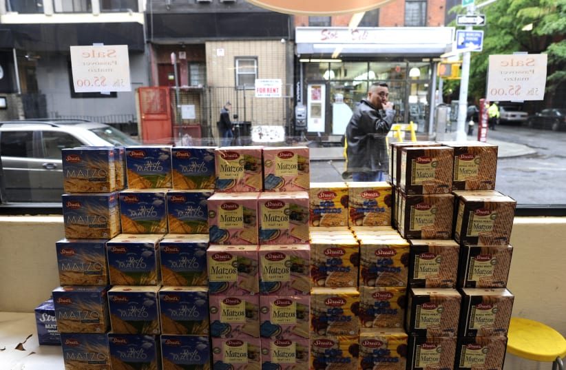Packages of Passover Matzos sit in the window of a store on the lower east side of New York  (photo credit: TIMOTHY A. CLARY / AFP)