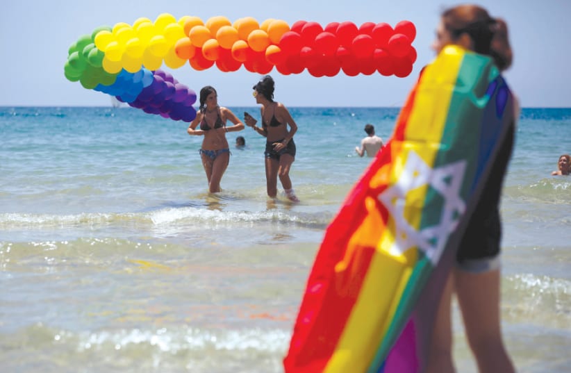 REVELERS DIP in the Mediterranean Sea as they take part in a Gay Pride parade in Tel Aviv last year (photo credit: AMIR COHEN/REUTERS)