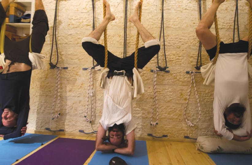 HAREDI MEN take part in a yoga class at a studio in Ramat Beit Shemesh in 2013 (photo credit: RONEN ZVULUN/REUTERS)