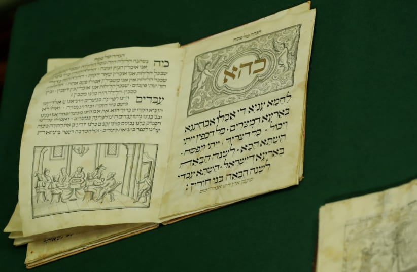 The Passover Hagada from the Guenzburg collection of ancient Hebrew manuscripts and books is pictured at the Russian State Library in Moscow, Russia November 7, 2017.  (photo credit: TATYANA MAKEYEVA/ REUTERS)