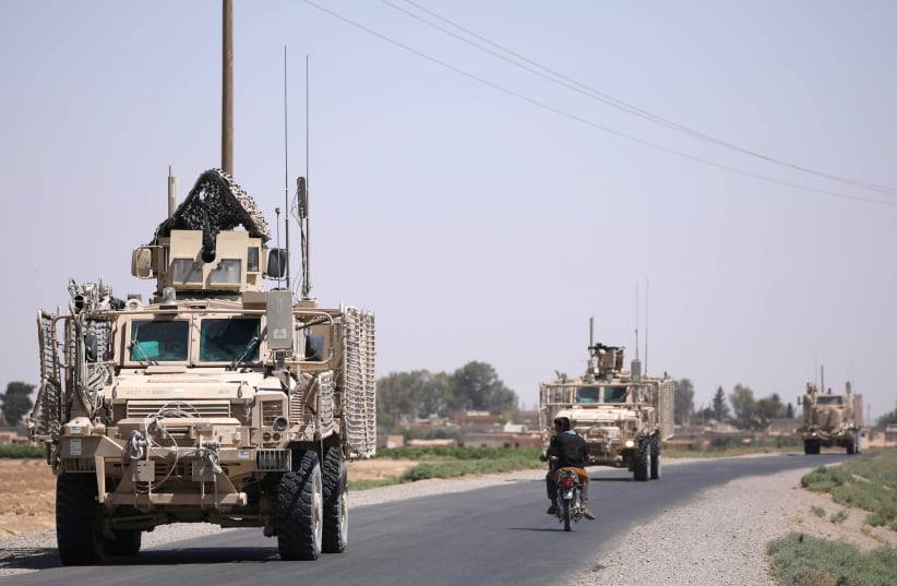 A US military convoy is seen on the main road in Raqqa, Syria July 31, 2017. (photo credit: REUTERS/RODI SAID)