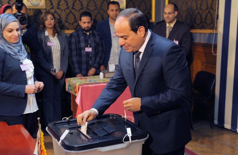 Egyptian President Abdel Fattah al-Sisi casts his vote during the presidential election in Cairo, Egypt March 26, 2018 (photo credit: THE EGYPTIAN PRESIDENCY/HANDOUT VIA REUTERS)
