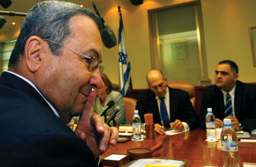 Then-defense minister Ehud Barak gestures as prime minister Ehud Olmert (center) convenes a cabinet meeting in Jerusalem on September 9, 2007 (photo credit: RONEN ZVULUN/REUTERS)