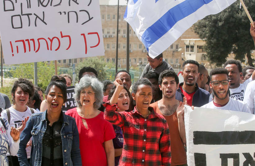 Jerusalem protest against the deportation of asylum seekers, the sign says "Don't play with human lives - [say] yes to the outlay.''   (photo credit: MARC ISRAEL SELLEM/THE JERUSALEM POST)