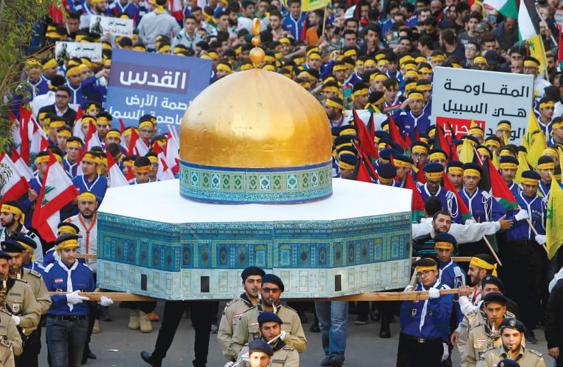 HEZBOLLAH SUPPORTERS carry a model of the Dome of the Rock during a rally in Beirut. (photo credit: REUTERS)