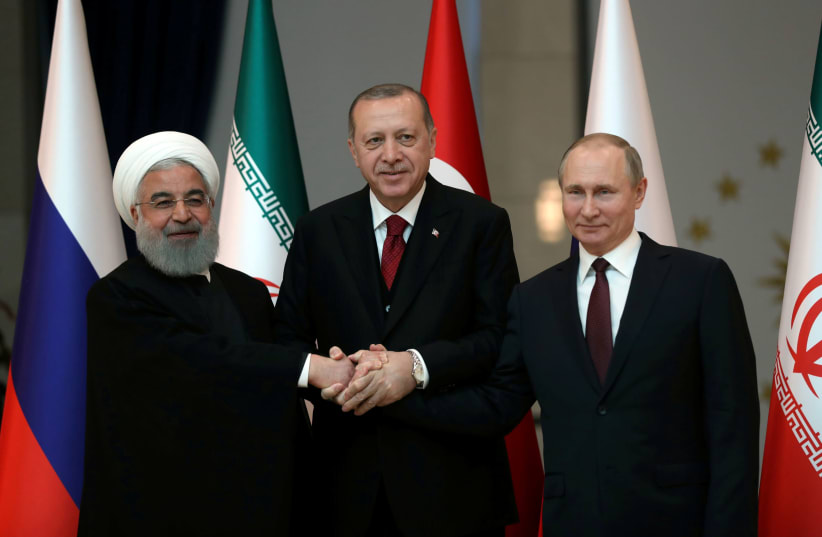 Presidents Hassan Rouhani of Iran, Tayyip Erdogan of Turkey and Vladimir Putin of Russia pose before their meeting in Ankara, Turkey April 4, 2018 (photo credit: TOLGA BOZOGLU/POOL VIA REUTERS)