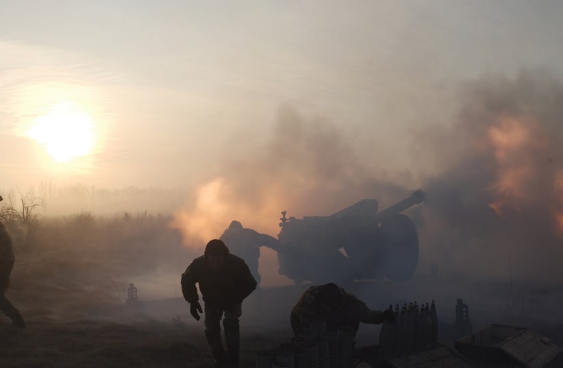 Ukrainian soldiers fire artillery during the conflict in Donbas (photo credit: REUTERS)
