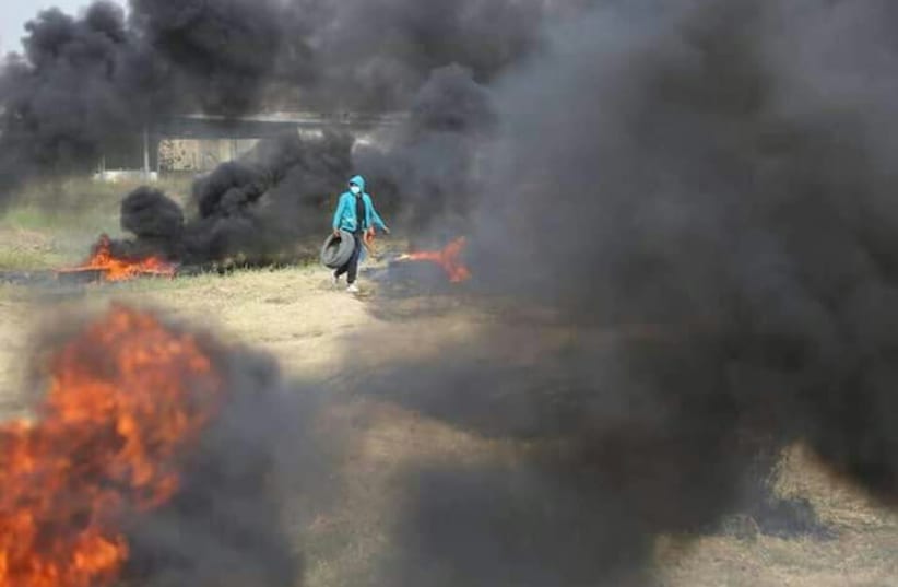 Palestinian protester burning tires  (photo credit: MAARIV)