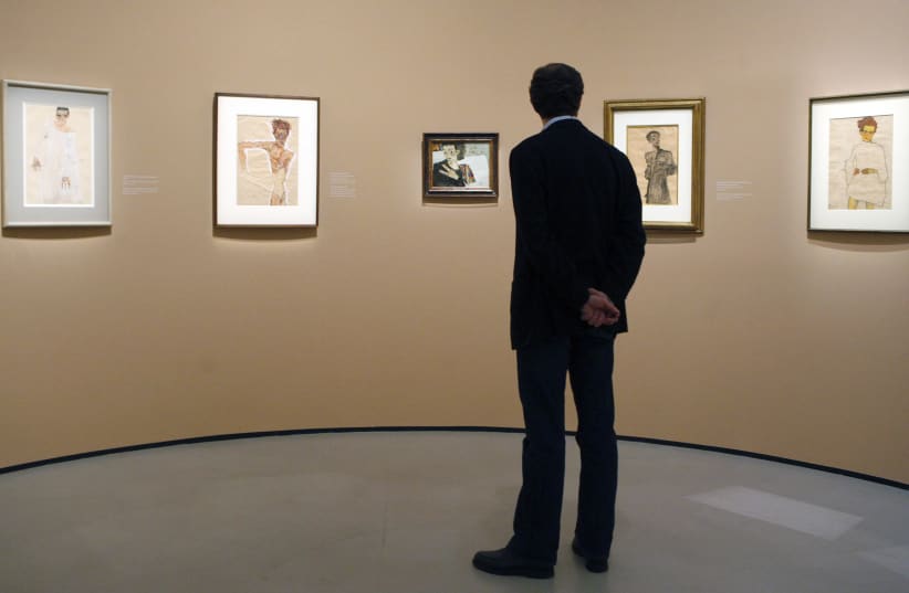 A man looks at self-portraits by Egon Schiele at the Belvedere museum in Vienna  (photo credit: REUTERS/HERWIG PRAMMER)