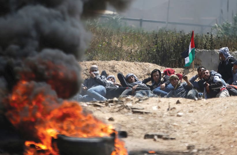 PALESTINIANS ATTEND a massive protest in Gaza on Friday. (photo credit: REUTERS)