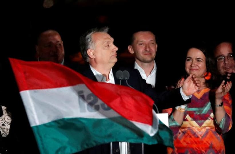 Hungarian Prime Minister Viktor Orban addresses supporters after the announcement of the partial results of parliamentary election in Budapest, Hungary, April 8, 2018 (photo credit: BERNADETT SZABO / REUTERS)