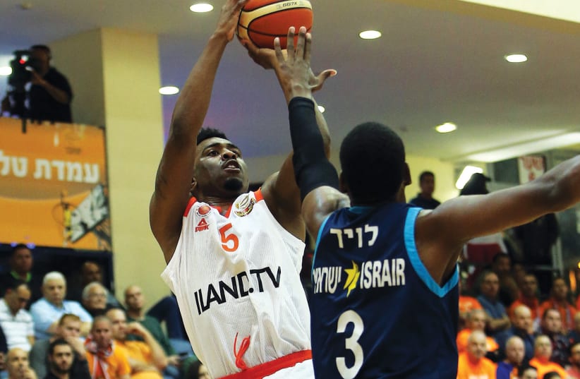 Maccabi Rishon Lezion guard Keith Langford (5) shoots over Hapoel Eilat’s Jordan Loyd during a 73-66 win for Rishon over Eilat in BSL action. (photo credit: UDI ZITIAT)
