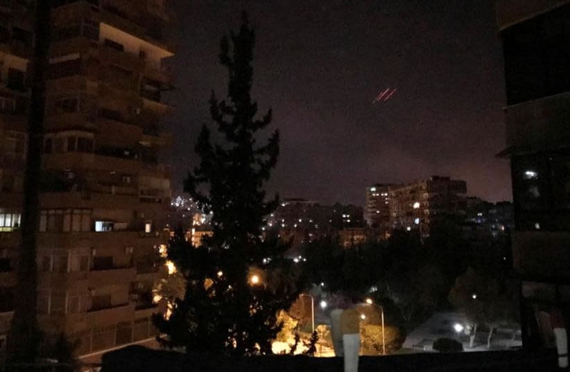 Anti-aircraft fire is seen over Damascus,Syria early April 14, 2018.  (photo credit: REUTERS/FERAS MAKDESI)