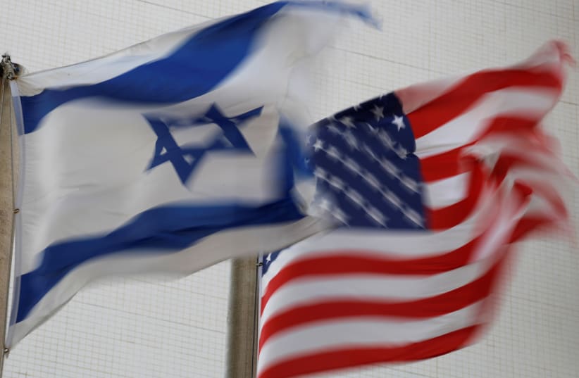 The American and the Israeli national flags can be seen outside the U.S Embassy in Tel Aviv, Israel December 5, 2017 (photo credit: AMIR COHEN - REUTERS)