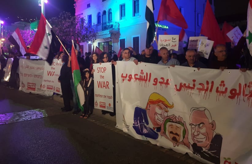 People protest the recent air strikes in Syria in front of the defunct US consulate in Haifa (photo credit: Courtesy)