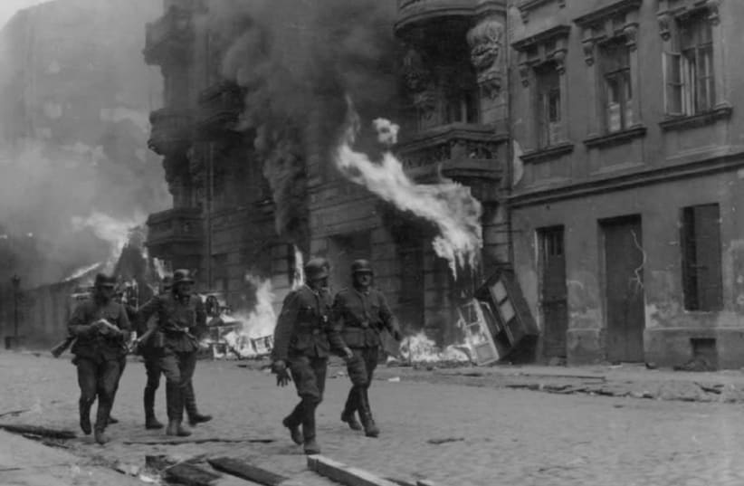 SS SOLDIERS patrol Nowolipie Street in the Warsaw Ghetto during the 1943 uprising (photo credit: Wikimedia Commons)