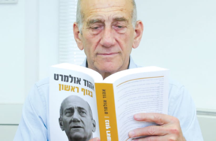 FORMER prime minister Ehud Olmert reads his new book (photo credit: MARC ISRAEL SELLEM)