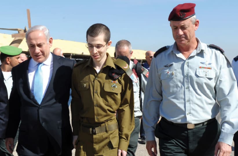 GERSHON BASKIN believes his greatest accomplishment is aiding in the talks that led to the release of captured IDF soldier Gilad Schalit (center), seen here shortly after his release from Gaza in October 2011 (photo credit: AVI OHAYON - GPO)