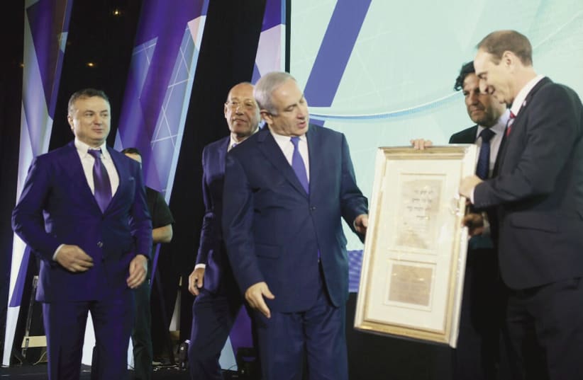 PRIME MINISTER Benjamin Netanyahu receives the Keren Hayesod Isaiah Award from Eliezer (Modi) Sandberg and David Koschitzky. (photo credit: AVI OHAYON - GPO)