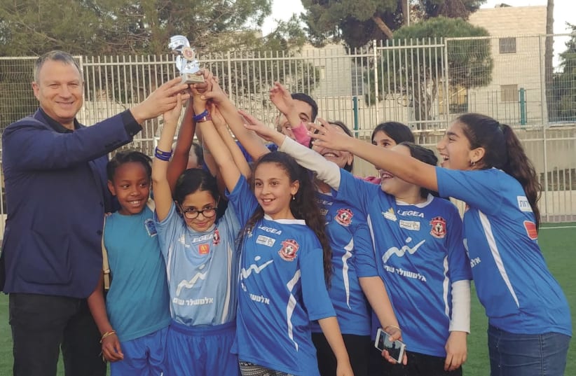 EREL MARGALIT celebrates with young soccer players in Jerusalem (photo credit: Courtesy)