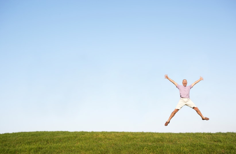 Happy man jumping in air (photo credit: INGIMAGE)