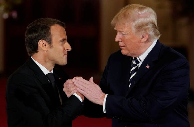 French President Emmanuel Macron shakes hands with U.S. President Donald Trump at the conclusion of their joint news conference in the East Room of the White House in Washington, U.S., April 24, 2018 (photo credit: REUTERS/JONATHAN ERNST)
