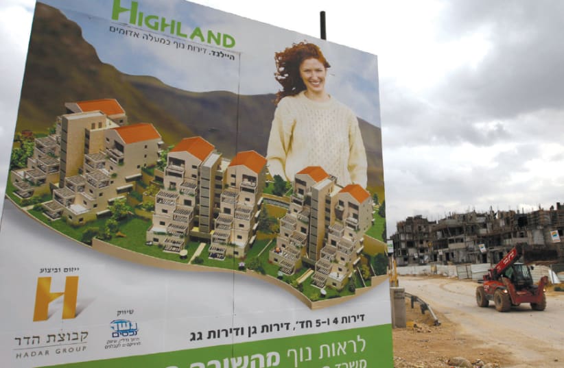 A BILLBOARD advertises new apartments for sale at a construction site in Ma’aleh Adumim in 2009 (photo credit: AMMAR AWAD/REUTERS)