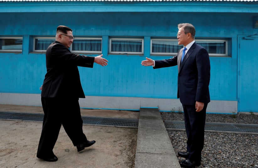 South Korean President Moon Jae-in and North Korean leader Kim Jong Un shake hands at the truce village of Panmunjom inside the demilitarized zone separating the two Koreas, April 27, 2018  (photo credit: KOREA SUMMIT PRESS POOL)
