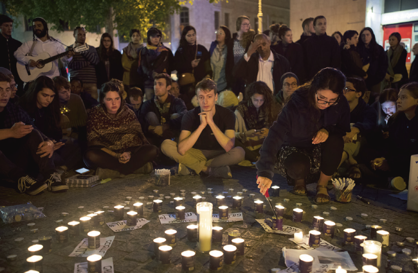 PEOPLE TAKE PART in a memorial in the capital’s Zion Square last night for the 10 teenagers who died in the Tzafit canyon disaster last week. (photo credit: YONATAN SINDEL/FLASH 90)