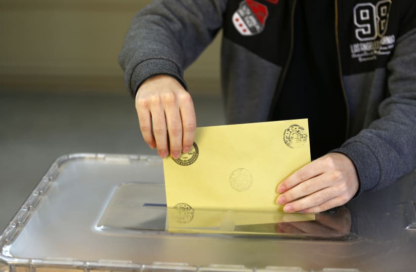 A Turkish man casts his ballot during elections (photo credit: OSMAN ORSAL/REUTERS)