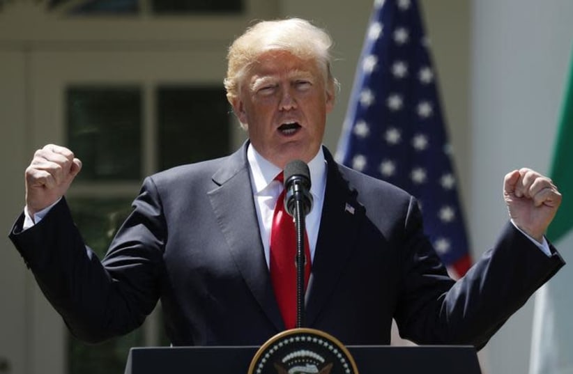U.S. President Donald Trump gestures while addressing a joint news conference with Nigeria's President Muhammadu Buhari in the Rose Garden of the White House in Washington, US, April 30, 2018. (photo credit: KEVIN LAMARQUE/REUTERS)