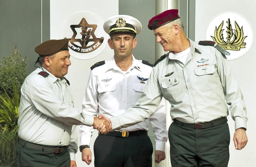 IDF Chief of Staff Lt.-Gen. Gadi Eisenkot (left) shakes hands with Lt.-Gen. Benny Gantz at the IDF headquarters in Tel Aviv in 2015  (photo credit: NIR ELIAS / REUTERS)