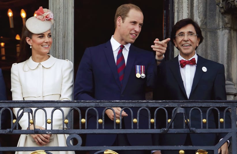 Britain's Prince William (center) and his wife, Kate, appear on a balcony at the Mons Town Hall with Belgian outgoing prime minister Elio Di Rupo in 2014 (photo credit: YVES HERMAN / REUTERS)