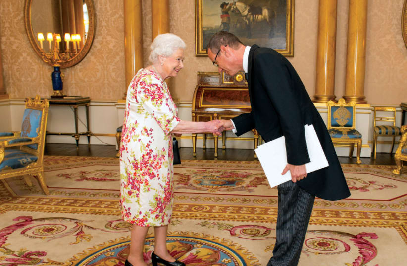 Israel’s UK Ambassador Mark Regev meets Queen Elizabeth at Buckingham Palace in 2016 (photo credit: DOMINIC LIPINSKI / POOL / REUTERS)