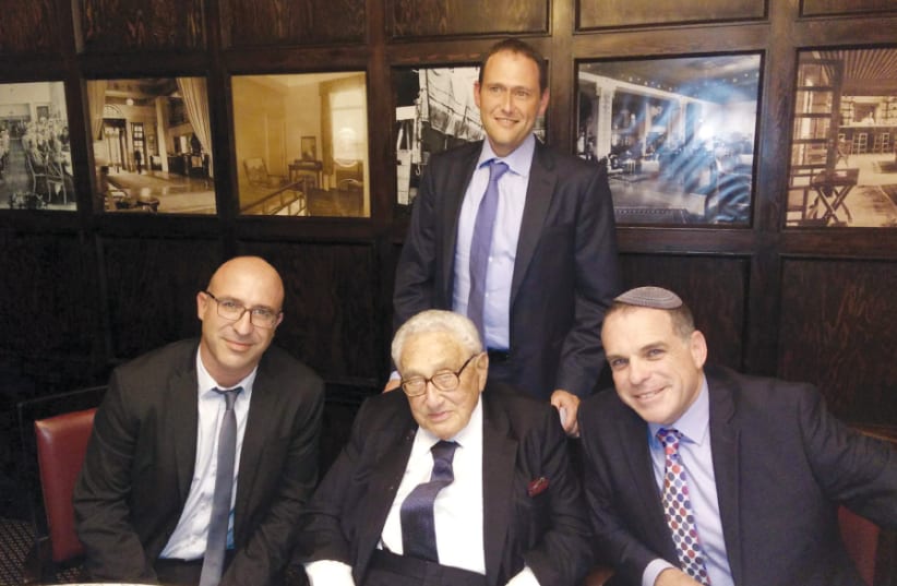 ODED REVIVI PAUSES for a photo during a meeting with former US secretary of state Henry Kissinger and Itai Ofir, legal counsel for security systems with the Defense Ministry (photo credit: ODED RAVIVI)