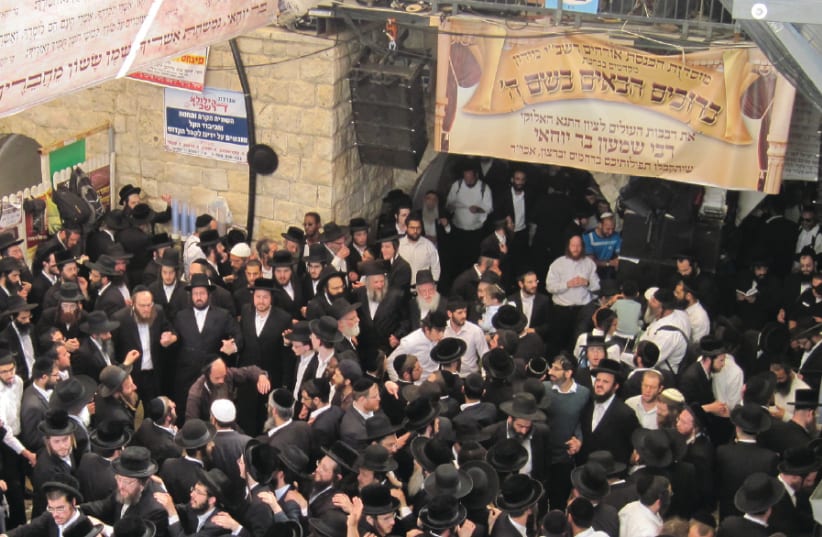 WORSHIPERS GATHER at the tomb of Rabbi Shimon Bar Yohai on Lag Ba’omer in 2016 in Meron (photo credit: Wikimedia Commons)