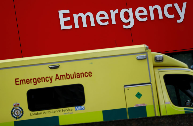 An ambulance waits outside the emergency department in London, Britain (photo credit: STEFAN WERMUTH/REUTERS)