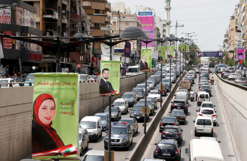 Campaign posters of Lebanese parliament candidates are seen in Beirut, Lebanon May 2, 2018 (photo credit: REUTERS/MOHAMED AZAKIR)