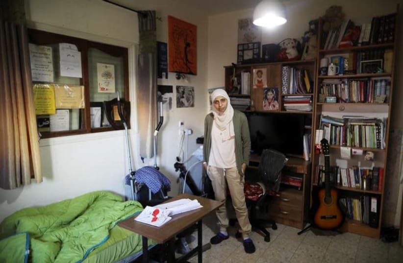 Arab-Israeli poet Dareen Tatour poses for a picture during an interview at her house in Reineh, northern Israel September 26, 2017. Picture taken September 26, 2017. (photo credit: AMMAR AWAD/REUTERS)
