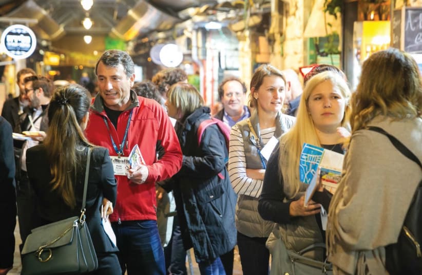 Visiting venture capitalists mingle and network in Jerusalem’s Mahaneh Yehuda market last week, as part of an annual Kauffman Fellows summit showcasing tech in the capital (photo credit: Courtesy)