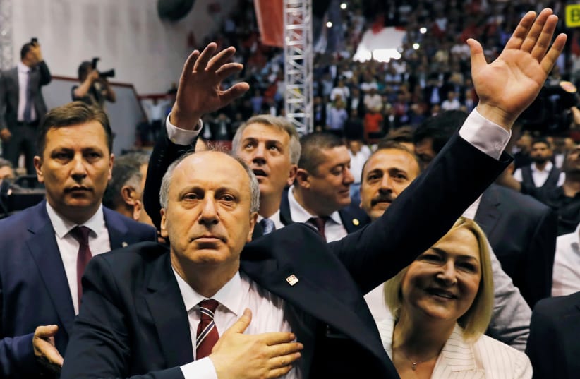 Muharrem Ince, Turkey's main opposition Republican People's Party (CHP) candidate for the upcoming snap presidential election, and his wife Ulku arrive for a party gathering in Ankara, Turkey, May 4, 2018. (photo credit: REUTERS/UMIT BEKTAS)