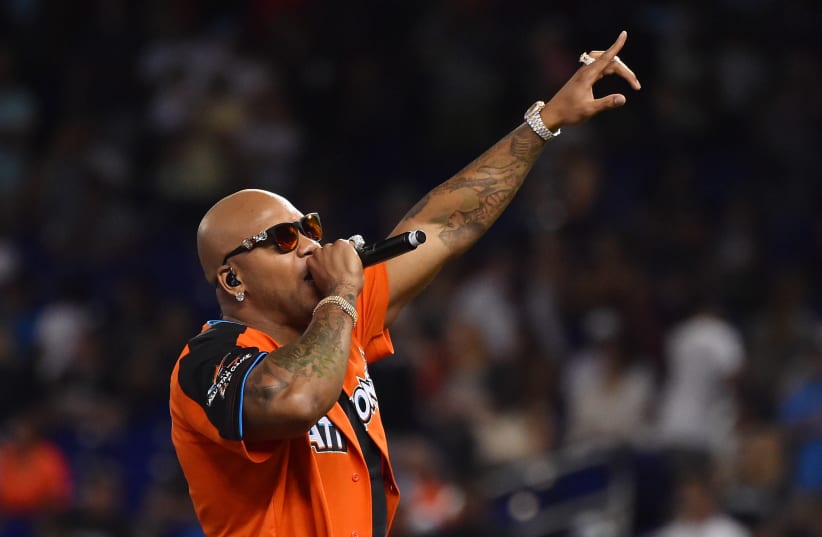 Recording artist Flo Rida performs before the MLB legends and celebrity softball game at Marlins Park (photo credit: JASEN VINLOVE-USA TODAY SPORTS / VIA REUTERS)