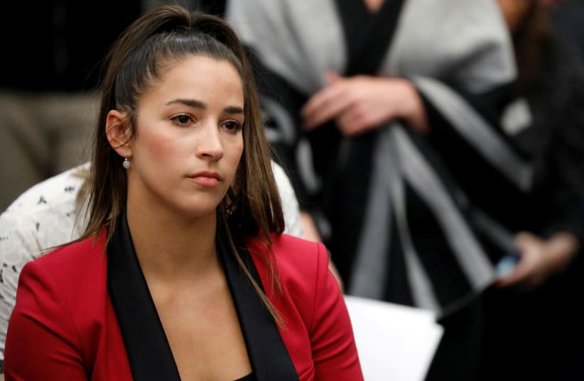 Victim and Olympic gold medalist Aly Raisman appears before speaking at the sentencing hearing for Larry Nassar, a former team USA Gymnastics doctor who pleaded guilty in November 2017 to sexual assault charges (photo credit: BRENDAN MCDERMID/REUTERS)