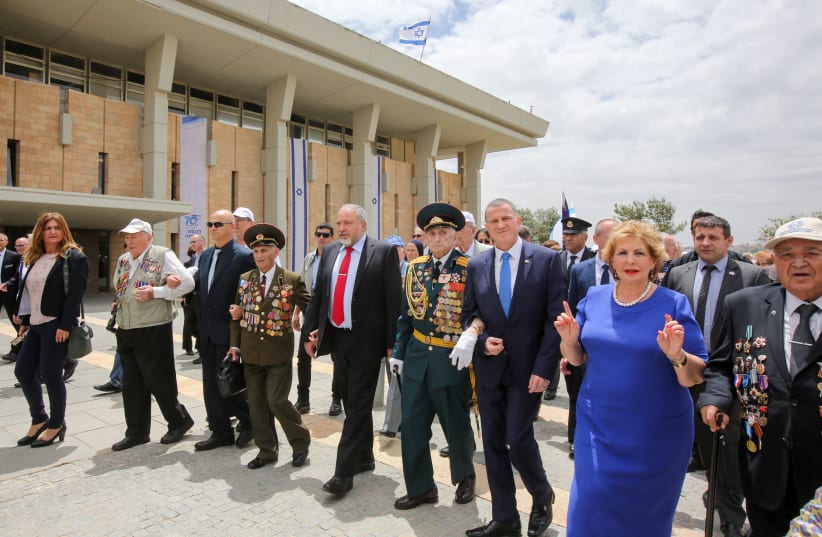 Knesset Speaker Yuli Edelstein (2nd from right) and Defense Minister Avigdor Liberman (fourth from right) march with World War II veterans during the Knesset's ceremony marking V-E Day, May 8th, 2018. (photo credit: MARC ISRAEL SELLEM/THE JERUSALEM POST)