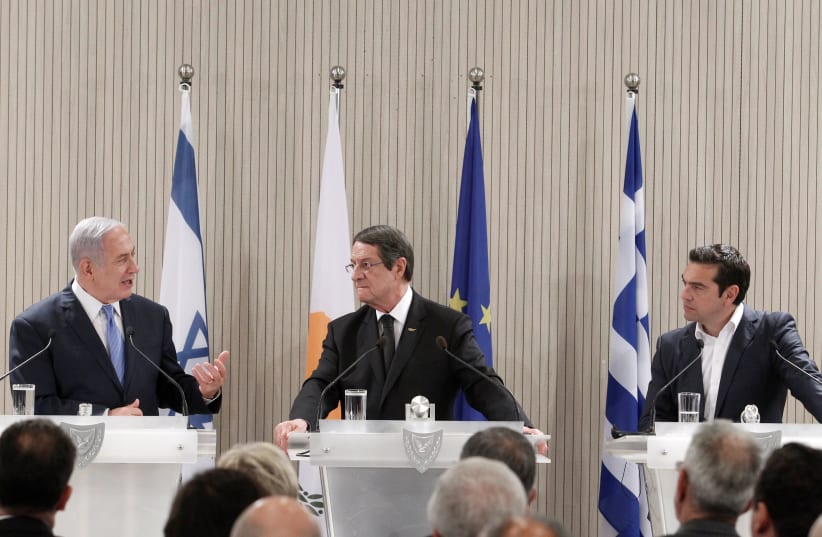 Cypriot President Nicos Anastasiades (C) Israeli Prime Minister Benjamin Netanyahu and Greek Prime Minister Alexis Tsipras attend a news conference at the Presidential Palace in Nicosia, Cyprus May 8, 2018. (photo credit: YIANNIS KOURTOGLOU/REUTERS)