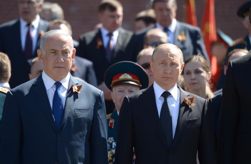 Prime Minister Benjamin Netanyahu and Russian President Vladimir Putin at the Victory Day parade in Moscow, May 2018 (photo credit: PMO)